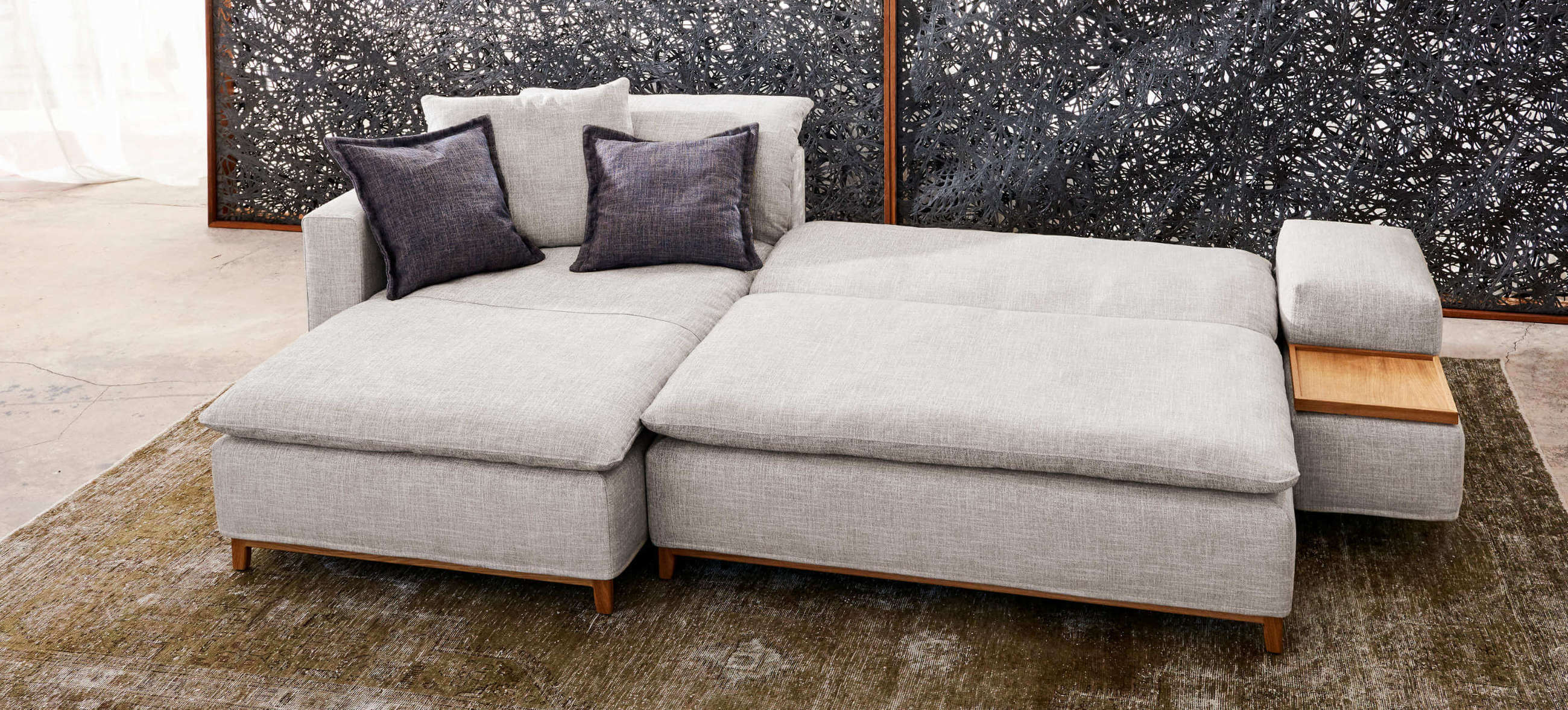 Isla Ecksofa von Signet – Schlafsofa mit großzügiger Liegefläche. Isla Ecksofa von Signet, ausgeklappt als Schlafsofa mit großzügiger Liegefläche und integriertem Holzdetail.